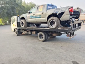 Rally truck on flatbed tow