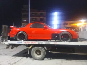 Tow truck flatbed towing sports car in Islamabad