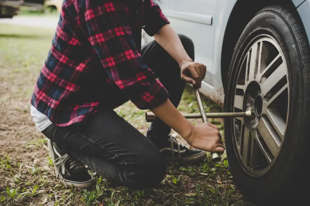 Person Fixing tyre on road